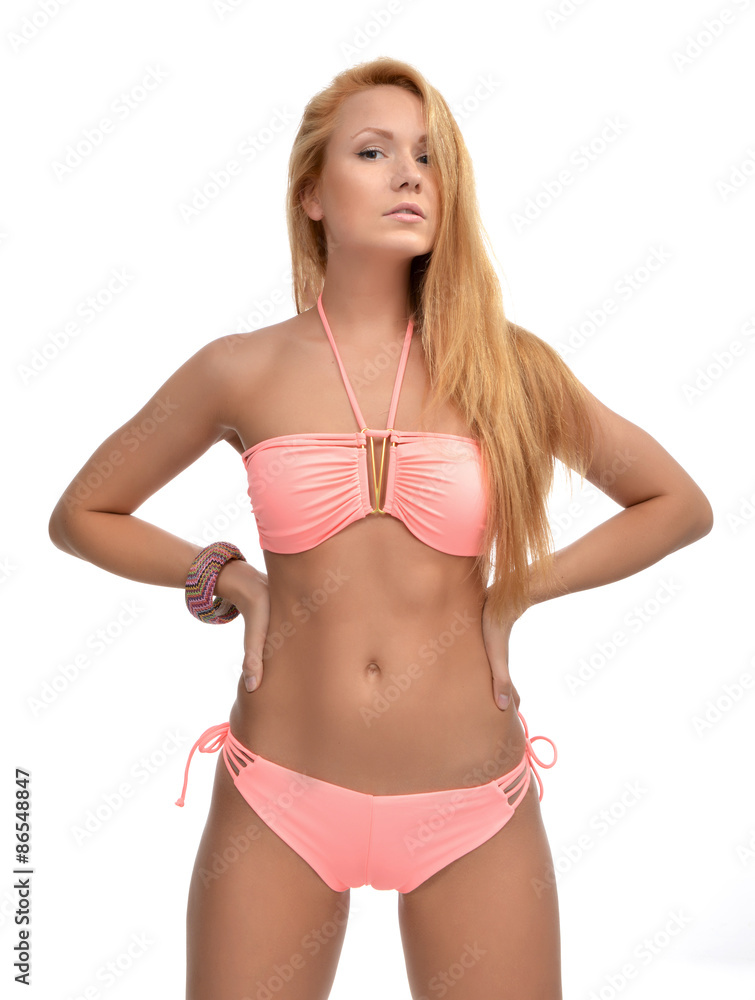 Naklejka premium Young beautiful woman posing in modern pink pattern bikini swims