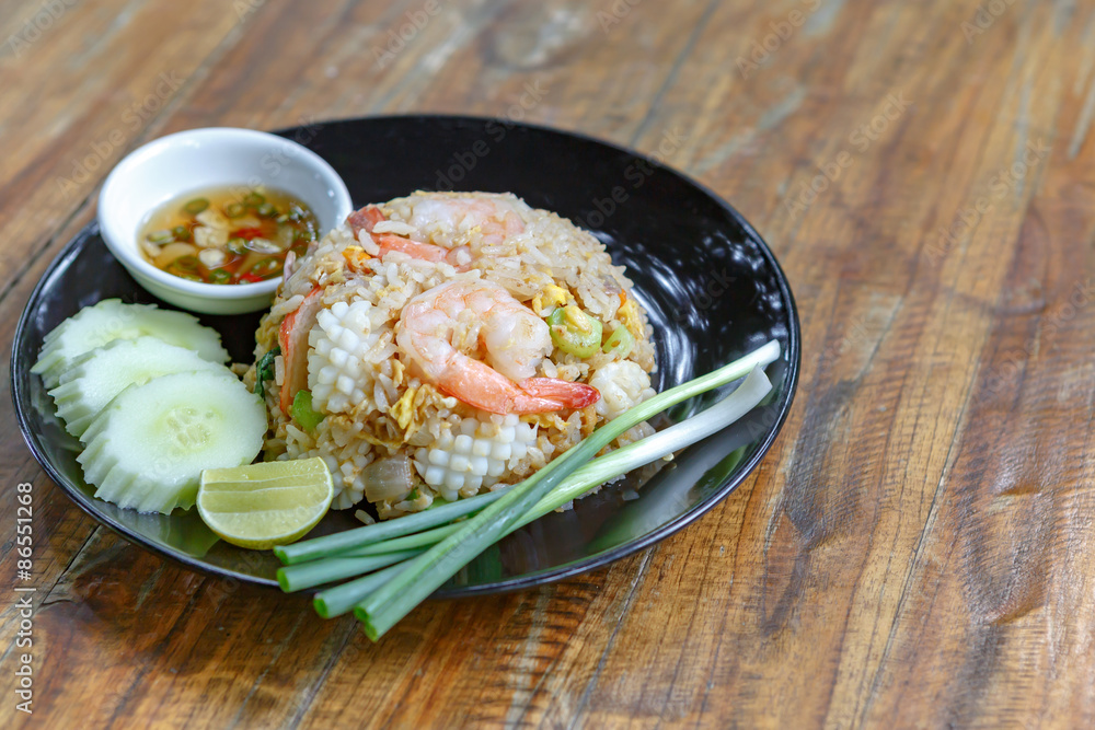 Thai fried rice on wooden desk Thai fried rice on wooden desk