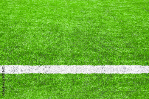 White stripe on the green soccer field.