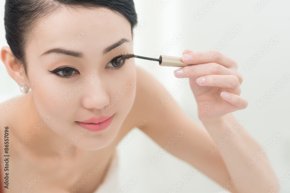 Applying mascara Applying mascara