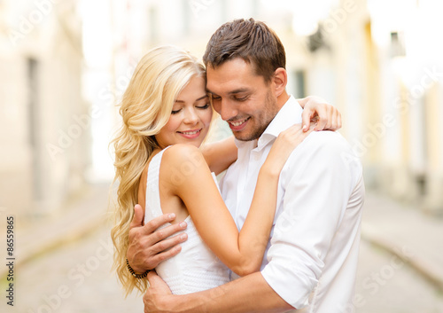 romantic happy couple hugging in the street