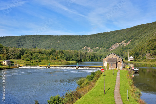 Dam on Meuse river in Ardennes, France near Fumay in sunny summer day
