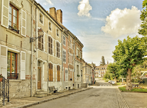 Styled photo of a traditional street in center of Fumay in Ardenne, France, with buildings from 17-18 centuries. Vintage look effects applied