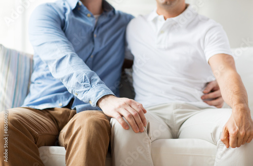 close up of happy male gay couple hugging at home