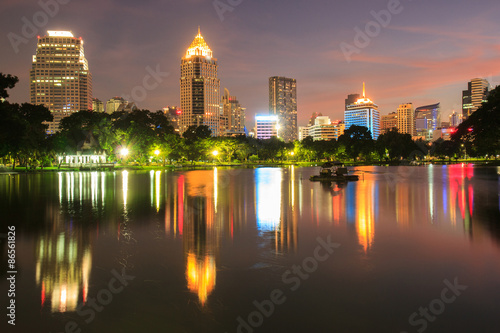 Business district cityscape from a park with Twilight Time from Lumpini Park  Bangkok  Thailand