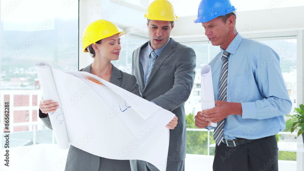 Team of architect looking at construction plan Team of architect looking at construction plan