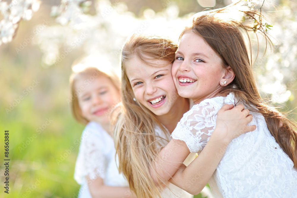 Portrait of little girls sisters in spring Portrait of little girls sisters in spring
