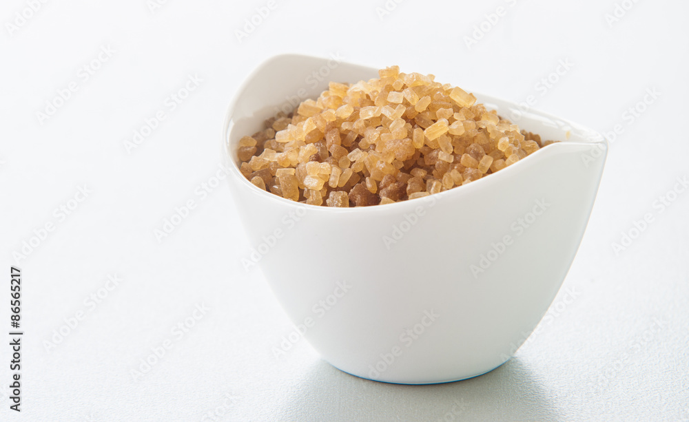 sugar in a white bowl on white background sugar in a white bowl on white background
