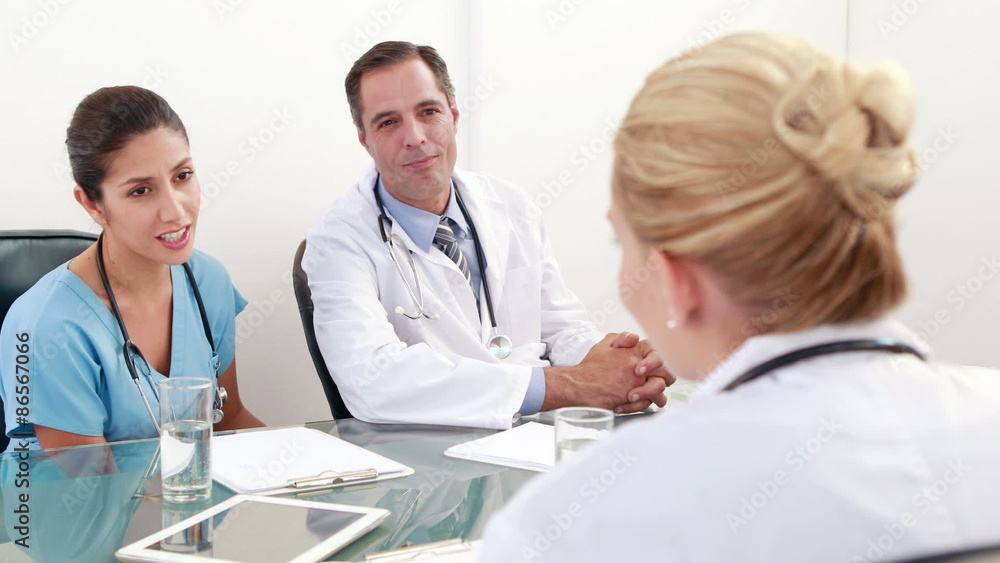Medical team speaking together during meeting Medical team speaking together during meeting