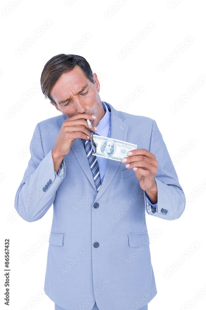 businessman burning a dollar banknote businessman burning a dollar banknote