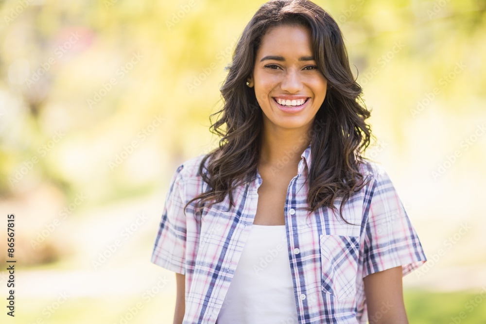 Pretty brunette looking at camera in the park Pretty brunette looking at camera in the park