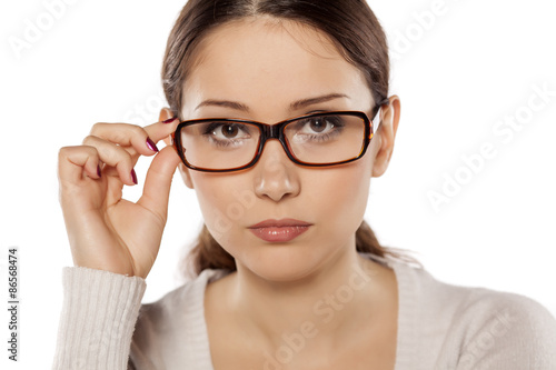 Beautiful serious woman posing with glasses