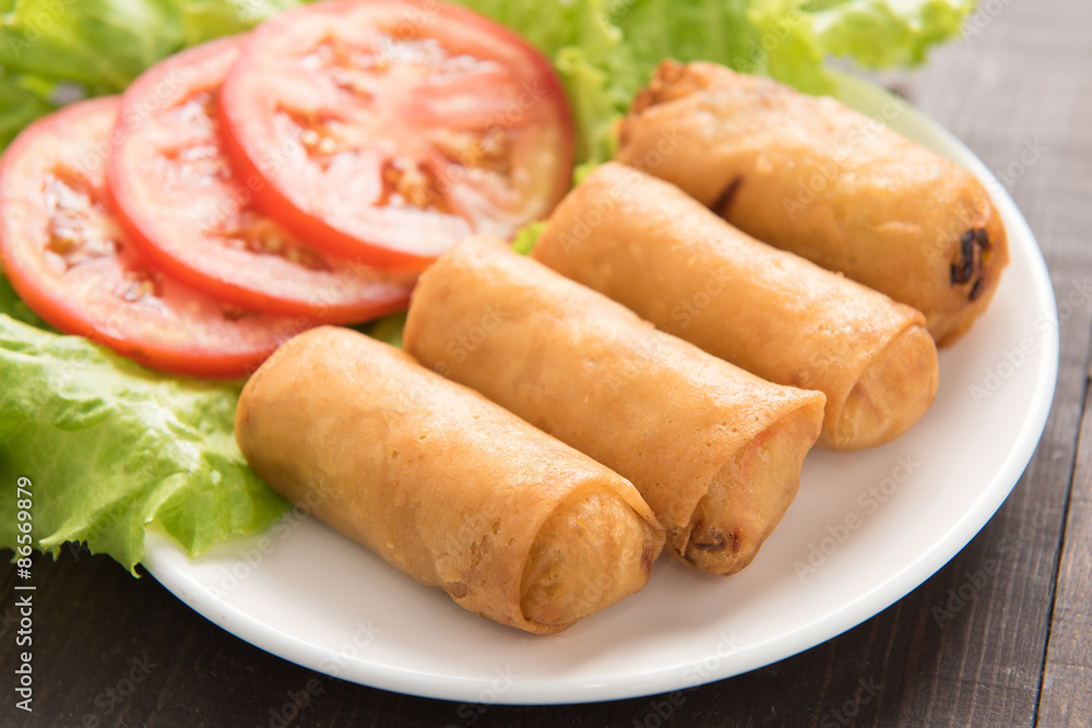 Fried Chinese traditional spring rolls on wooden background. Fried Chinese traditional spring rolls on wooden background.