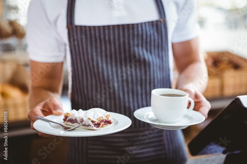 Smiling worker prepares breakfast