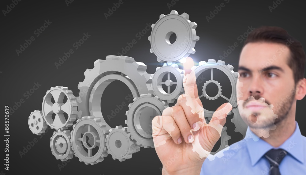 Composite image of businessman measuring gears Composite image of businessman measuring gears