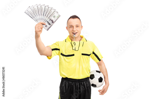 Fotografija Young male football referee holding a stack of money