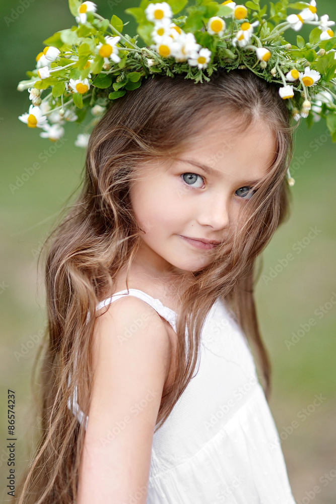portrait of a beautiful little girl with flowers portrait of a beautiful little girl with flowers