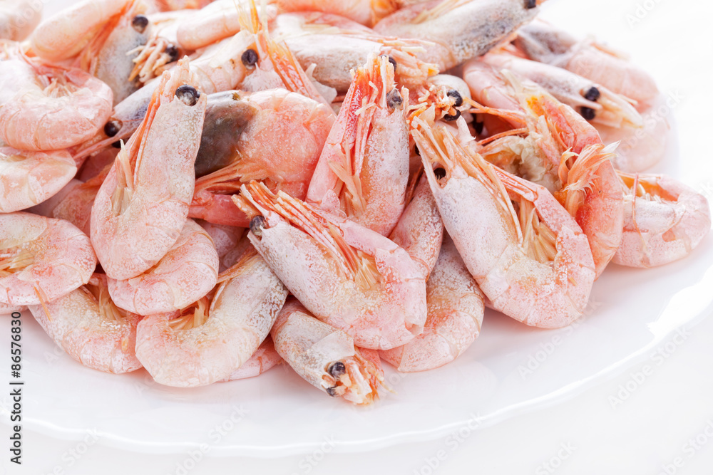 Pile of frozen shrimps on plate