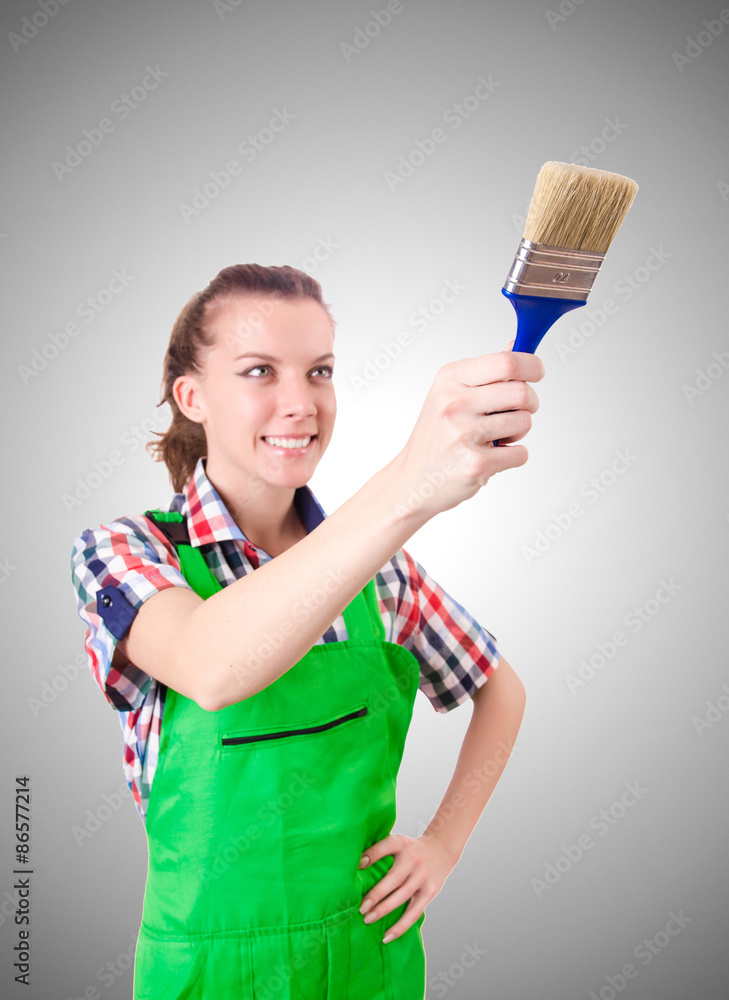 Woman painter with paintbrush against gradient Woman painter with paintbrush against gradient