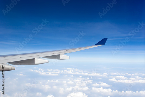 Wing of airplane in blue sky