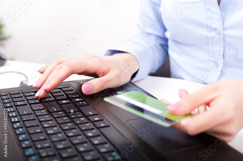 Business woman with credit card  typing