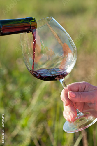 Wine pouring from bottle, outdoor