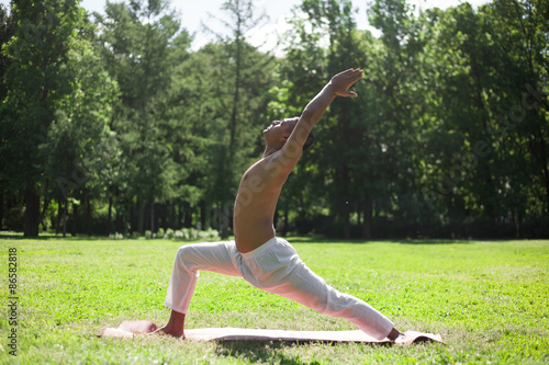 Crescent yoga pose in park © fizkes