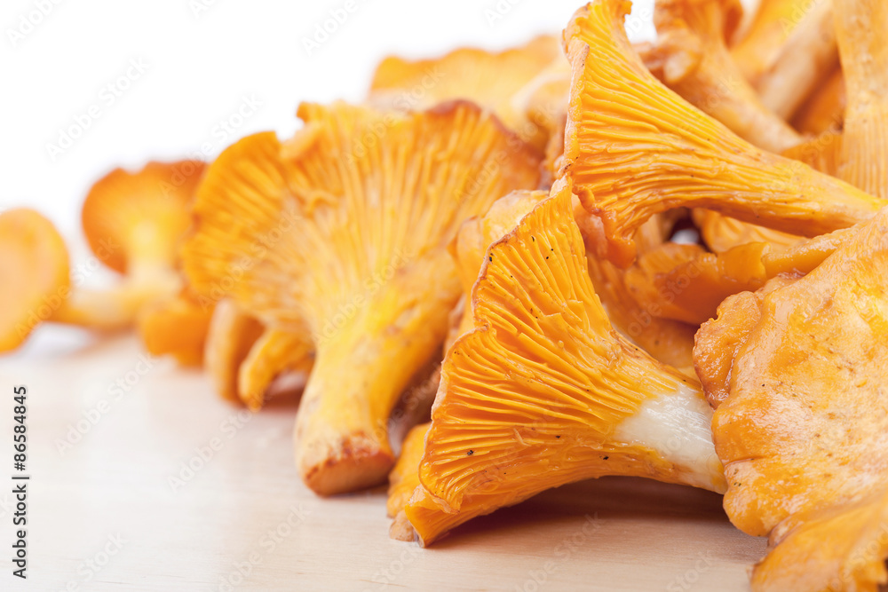 Chanterelles on wooden table Chanterelles on wooden table