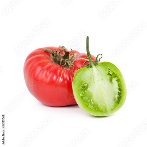 Wallpaper Mural Red tomato and half of green tomato on white Torontodigital.ca