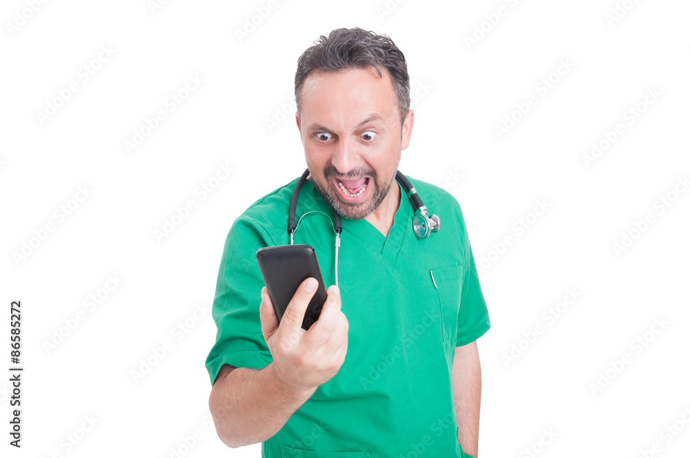 Angry doctor looking and yelling at his smartphone Angry doctor looking and yelling at his smartphone