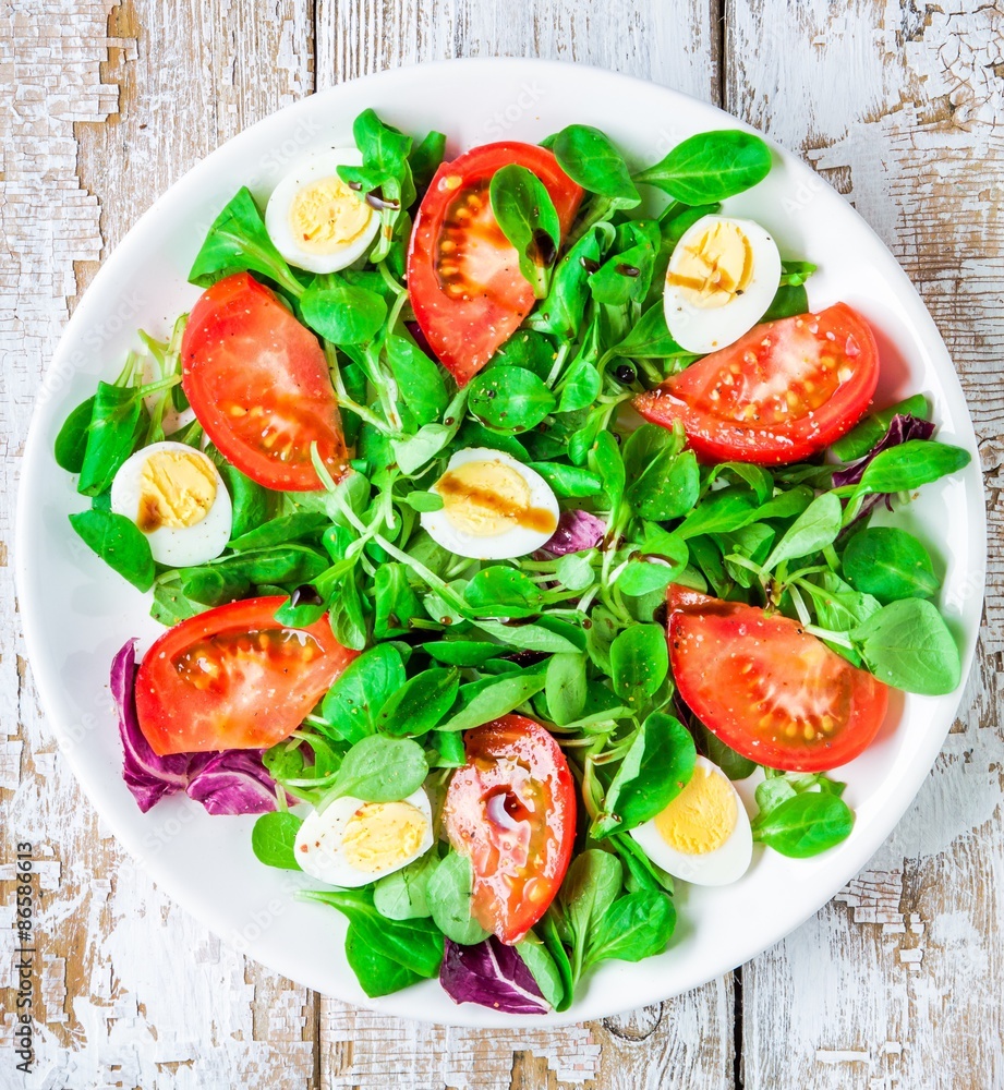 fresh green salad with lamb's lettuce, tomatoes and quail eggs fresh green salad with lamb's lettuce, tomatoes and quail eggs