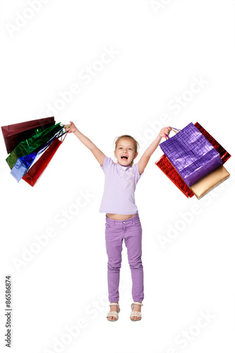 Happy girl with shopping bags standing at studio 