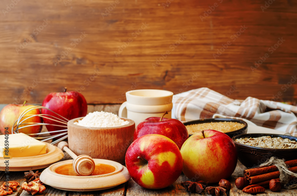baking wood background with apples, nuts, honey, flour and butte