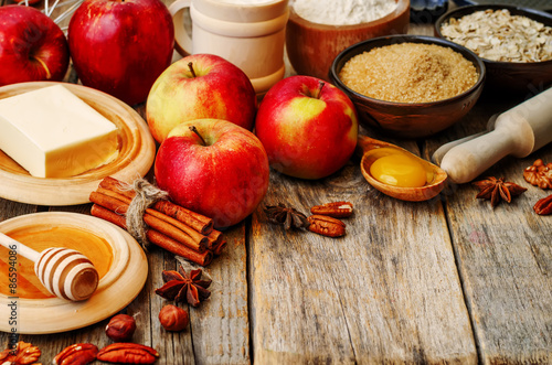 Fototapeta Naklejka Na Ścianę i Meble -  baking wood background with apples, nuts, honey, flour and butte
