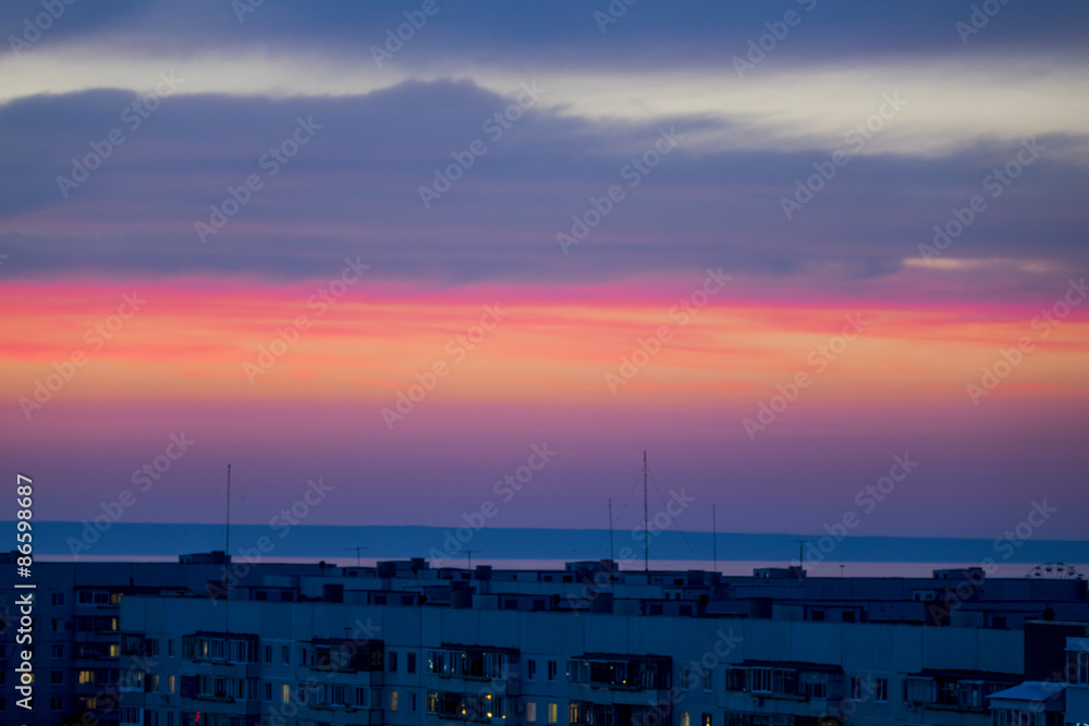 Unusual red sunset. Clouds with gray and crimson shades.
