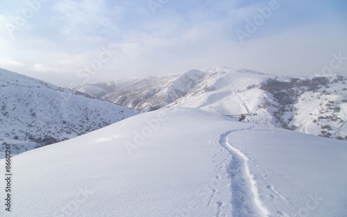Trail in the snow in the mountains © schankz
