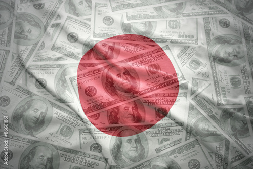 colorful waving japanese flag on a american dollar money background
