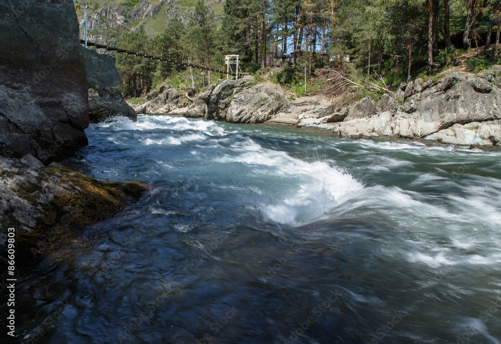During the stormy mountain river among stones During the stormy mountain river among stones