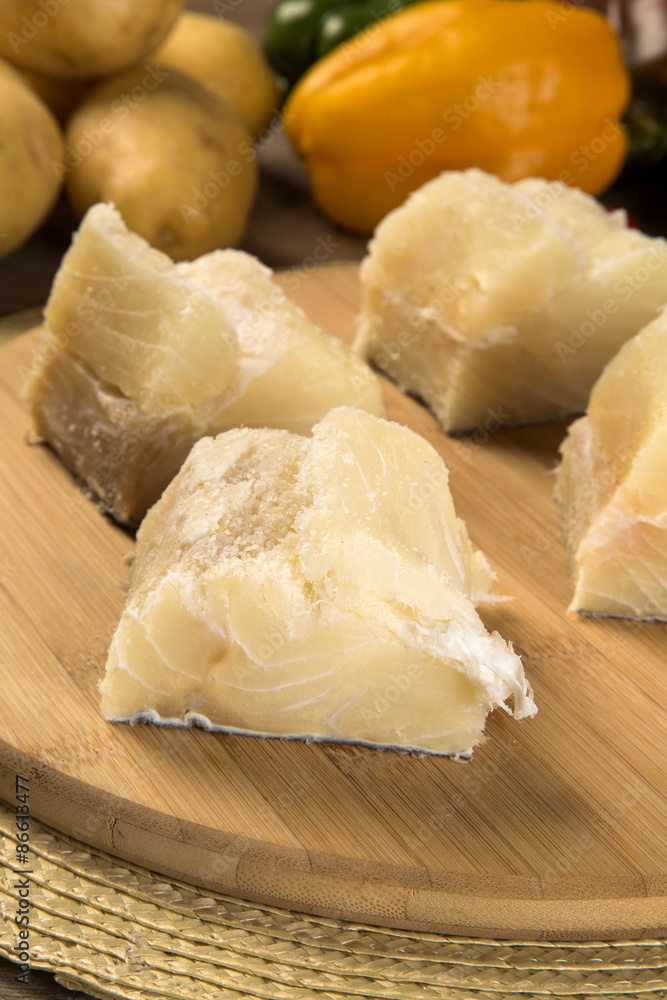 salted codfish on the wooden table with ingredients salted codfish on the wooden table with ingredients