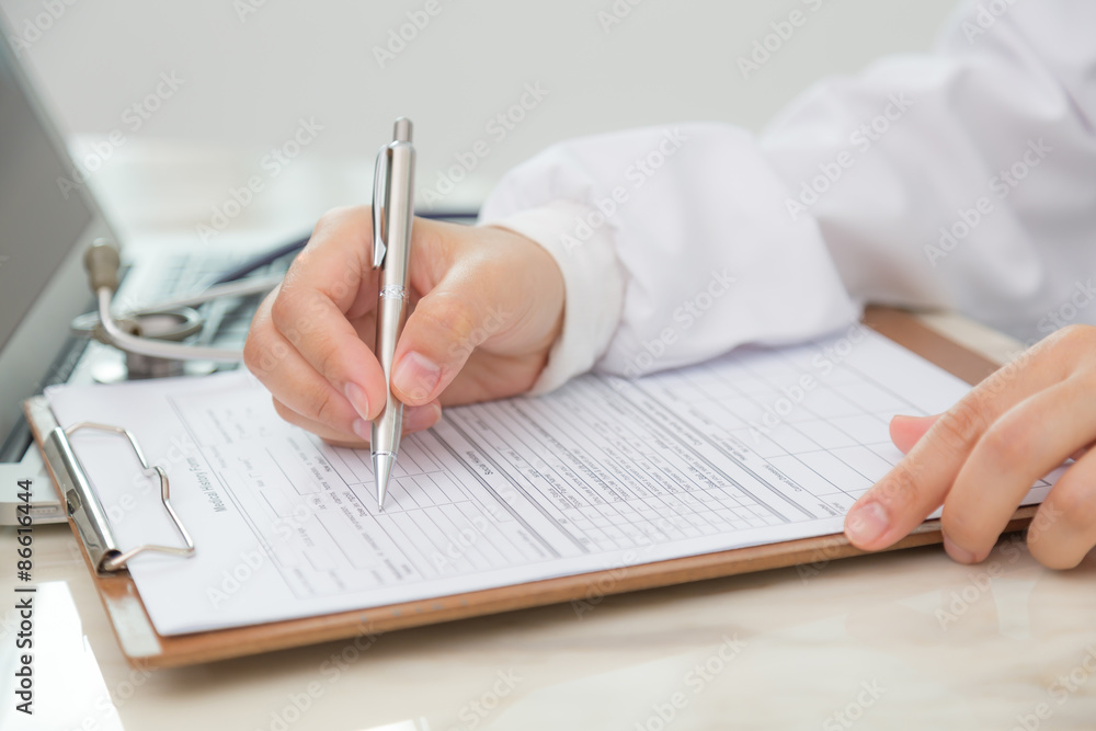 Hand of doctor writing on prescription Hand of doctor writing on prescription