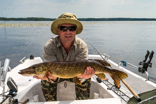 Man with summer pike fish