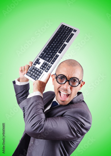 Nerd businessman with computer keyboard against gradient 