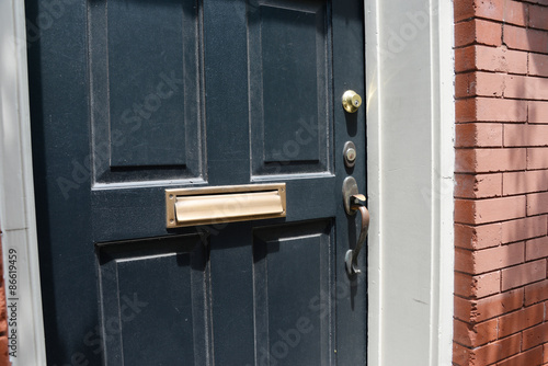 Brass mail slot on door