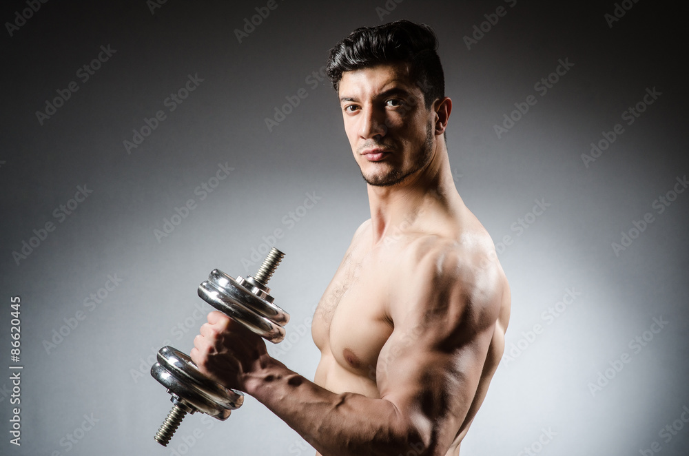 Muscular ripped bodybuilder with dumbbells Muscular ripped bodybuilder with dumbbells