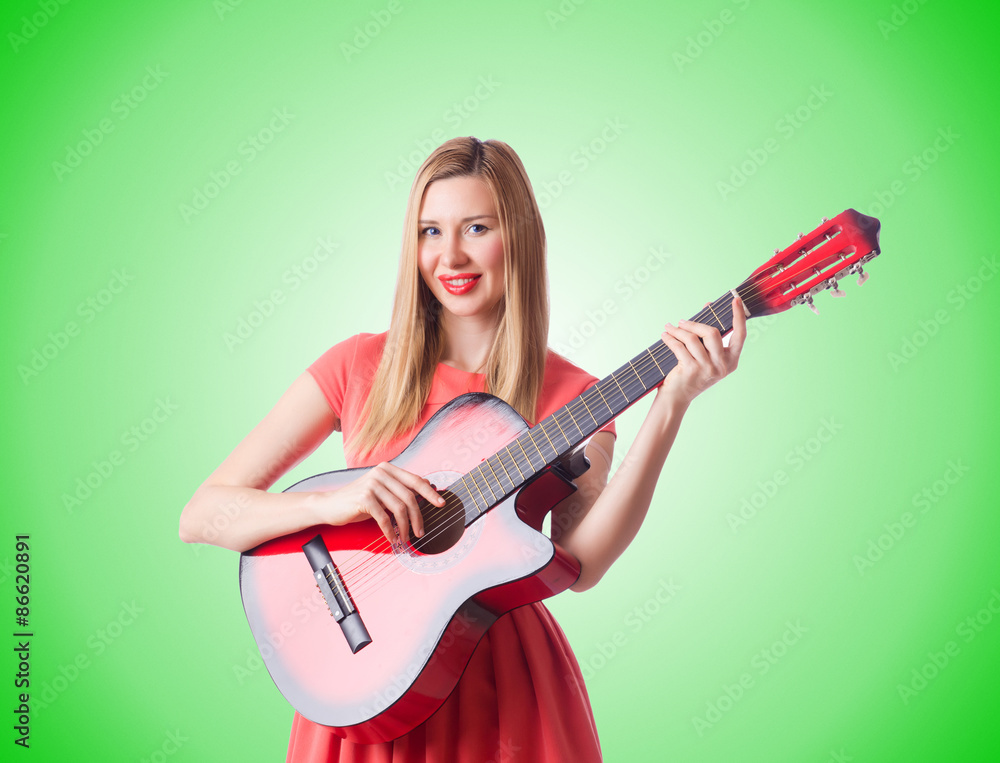 Woman playing guitar against the gradient 