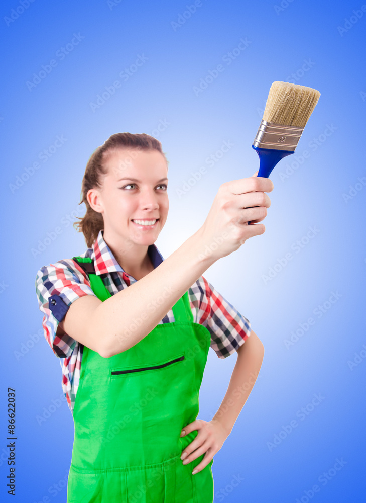 Woman painter with paintbrush against gradient Woman painter with paintbrush against gradient