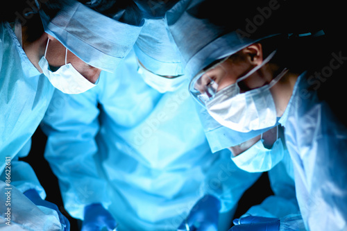 Team surgeon at work in operating room photo