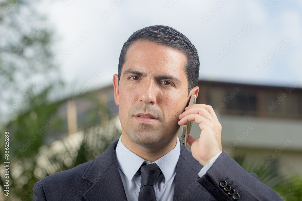 Portrait Of Young Latin Businessman Using Cell Phone Portrait Of Young Latin Businessman Using Cell Phone