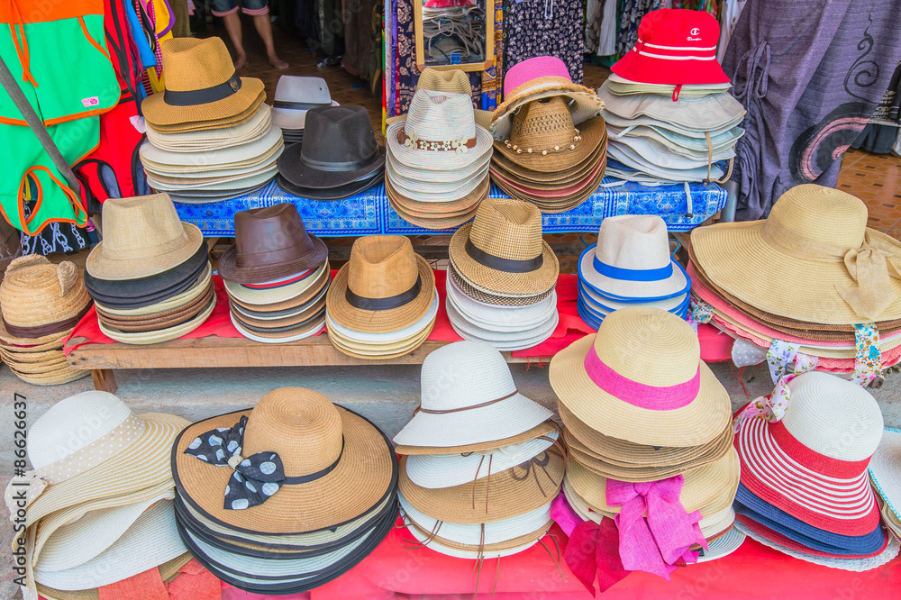 Colorful summer hats lie for sale
