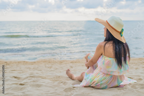 Happy woman enjoying beach relaxing joyful in summer by tropical